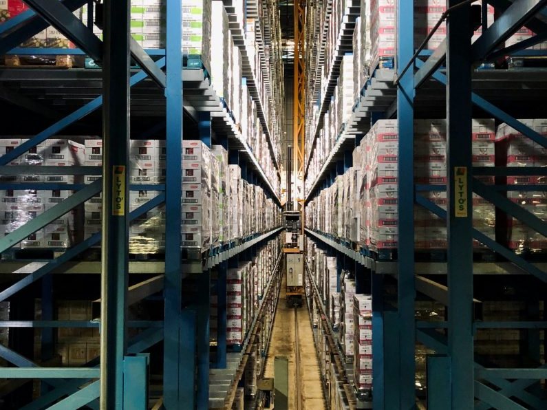 A tall aisle between racking in an automated warehouse